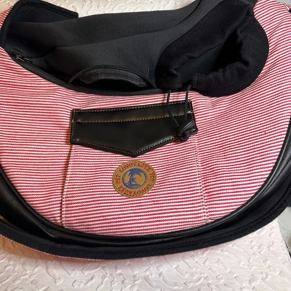 Pet carrier bag strap has a cell phone holder. The strap is padded like new.
